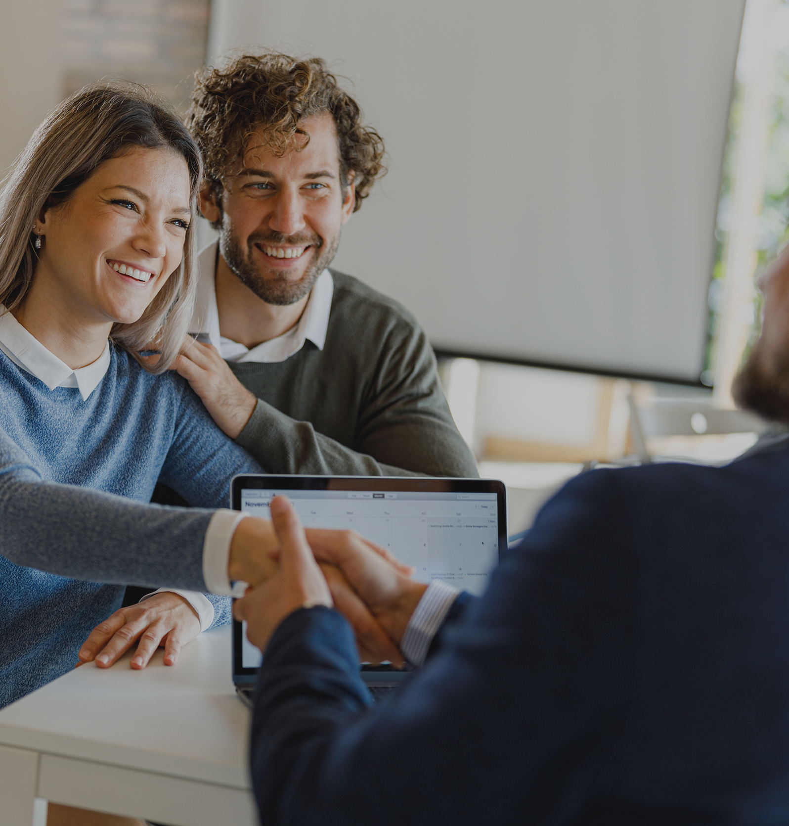 Real Estate Agent speaking with two clients