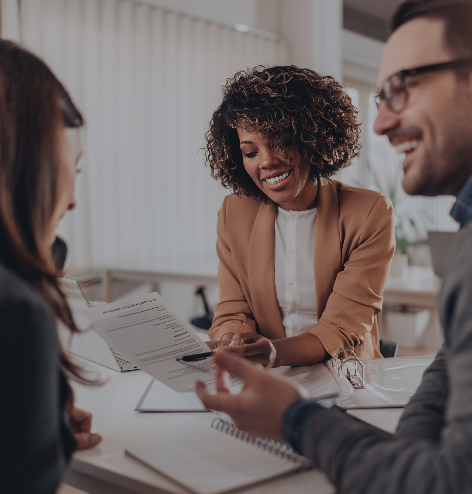 Real Estate Agent speaking with two clients